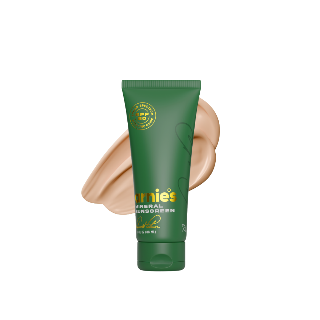 Green tube of Jemies sunscreen with a swatch on a white background