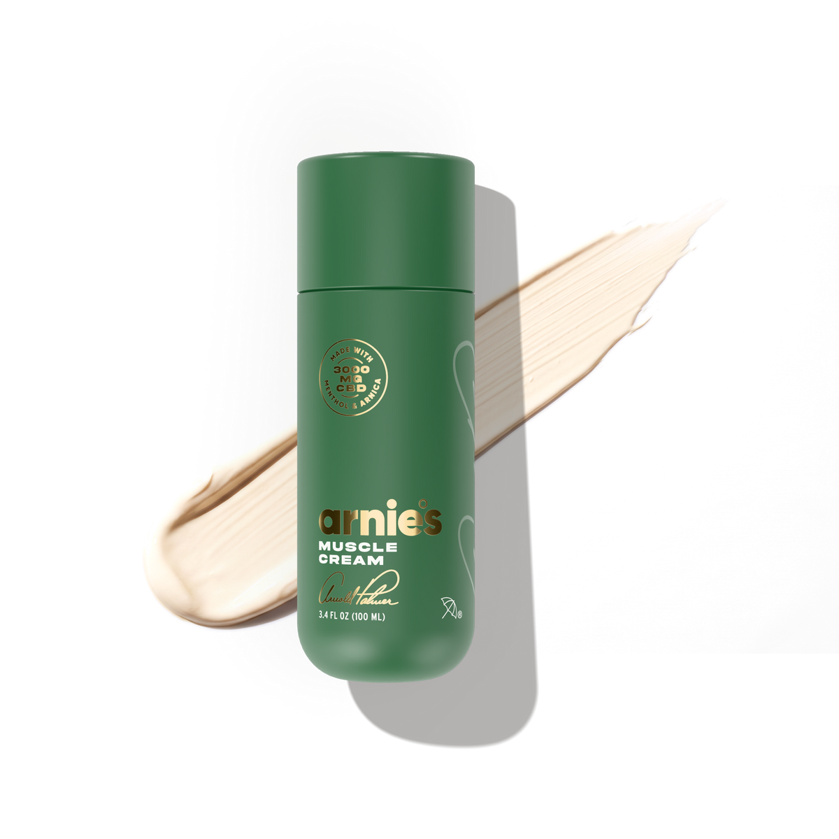 Arnie's Muscle Cream bottle over a swipe of the ivory white cream.